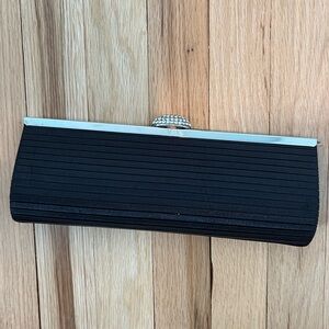 Satin like evening bag with rhinestone clasp.